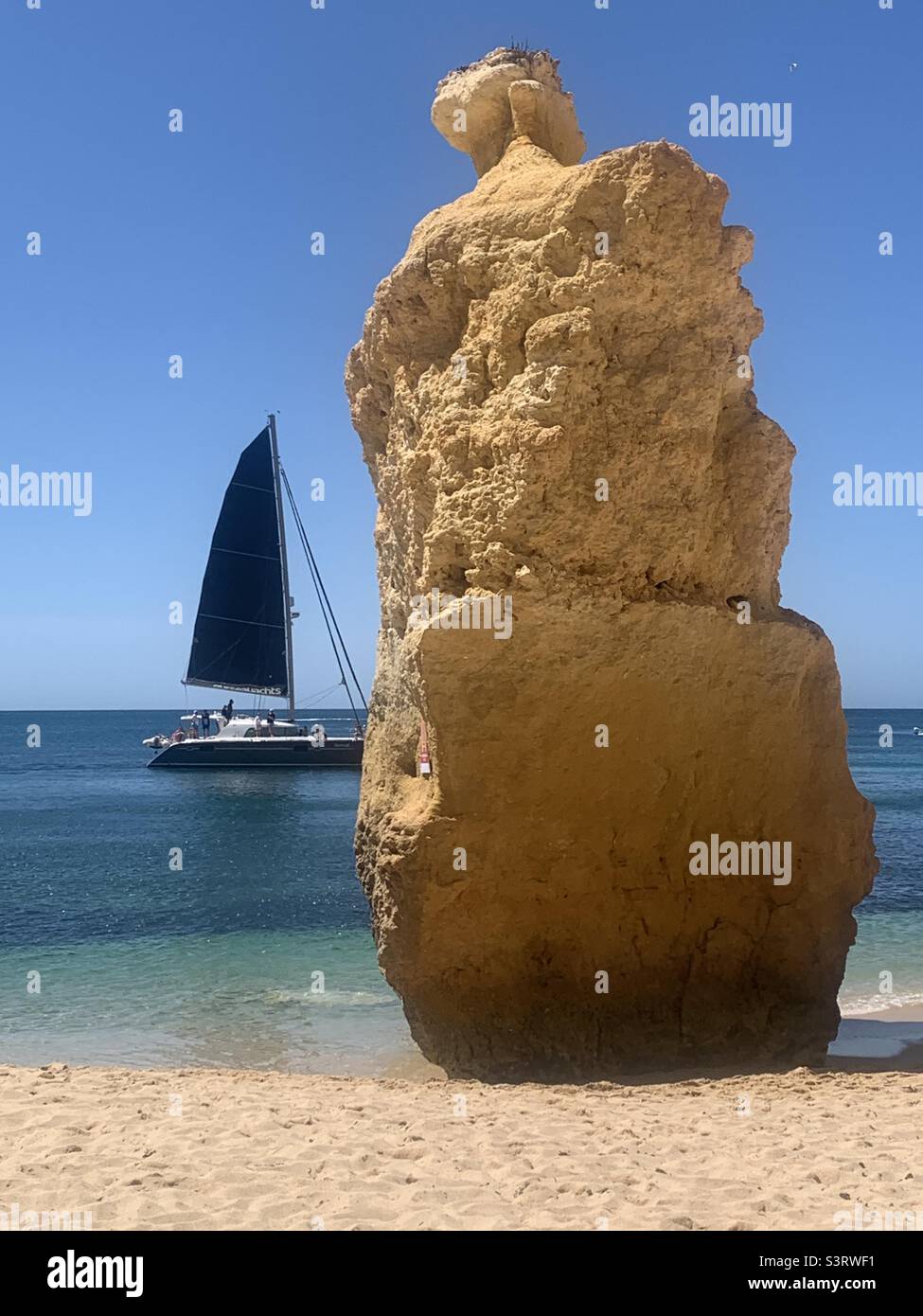 Sailboat and rock at Praia da Marinha Portugal - Smartphone Captured Stock Image