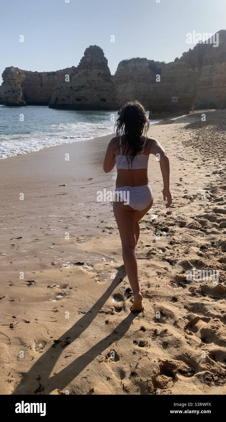 Woman running on beach Portugal - Smartphone Captured Stock Image