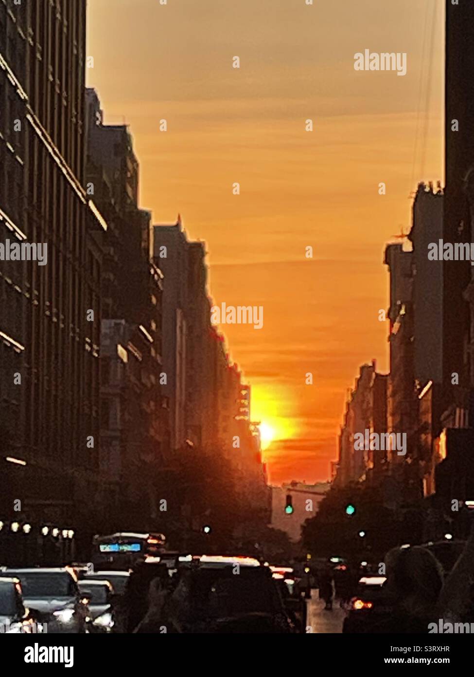 A vivid sunset between buildings in New York City Stock Photo