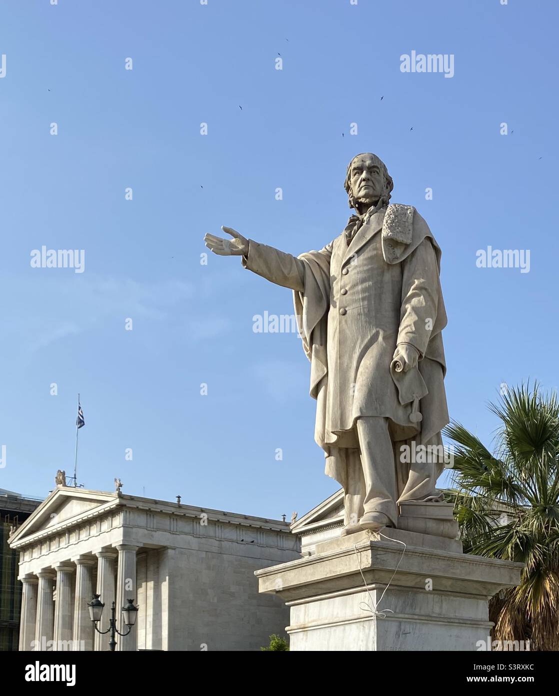 Statue of the British Prime Minister W E Gladstone (1809-98) by Vitalis, before the old National University of Athens building, Greece. He was a classical scholar who wrote a 500 page book on Homer. Stock Photo