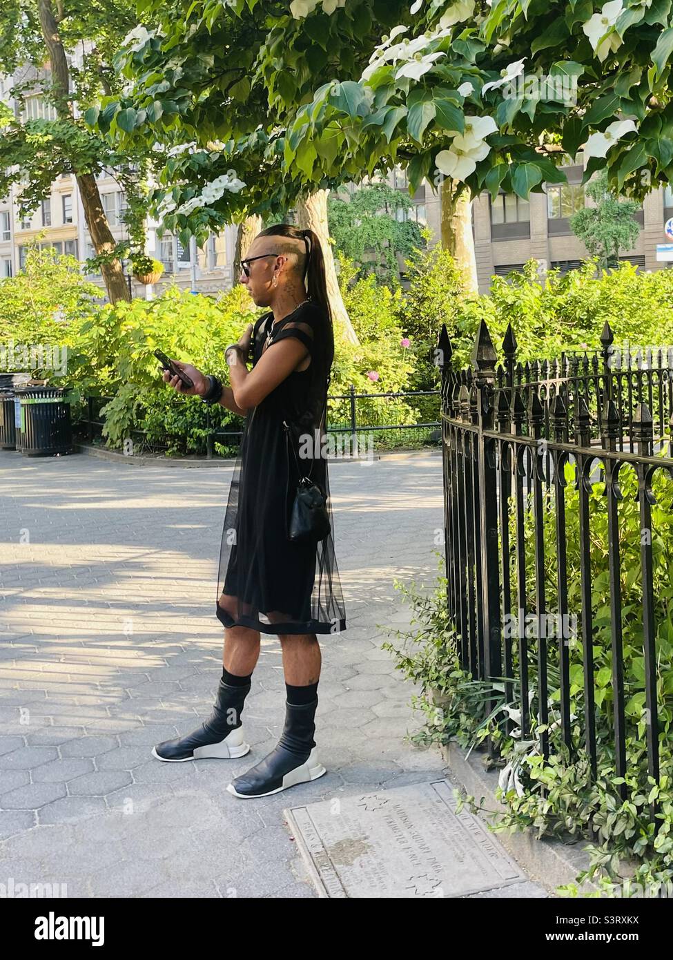 Person standing by trees in the park - Smartphone Captured Stock Image
