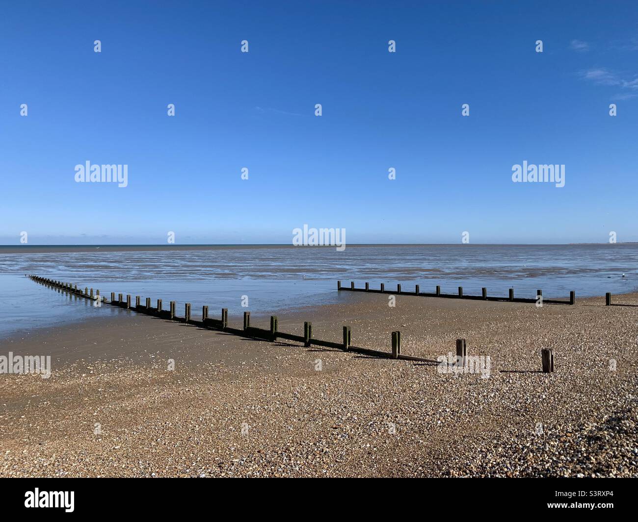 Groynes on pebbly beach in Kent Stock Photo