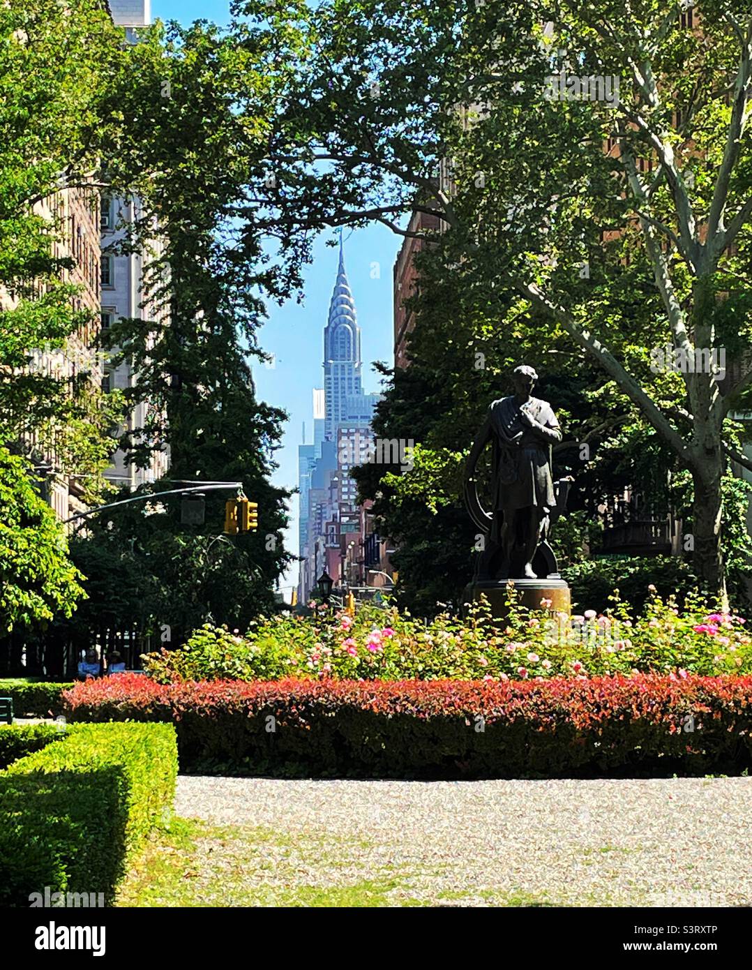 The statue of Edwin booth with the Chrysler building in the background as seen in Gramercy Park