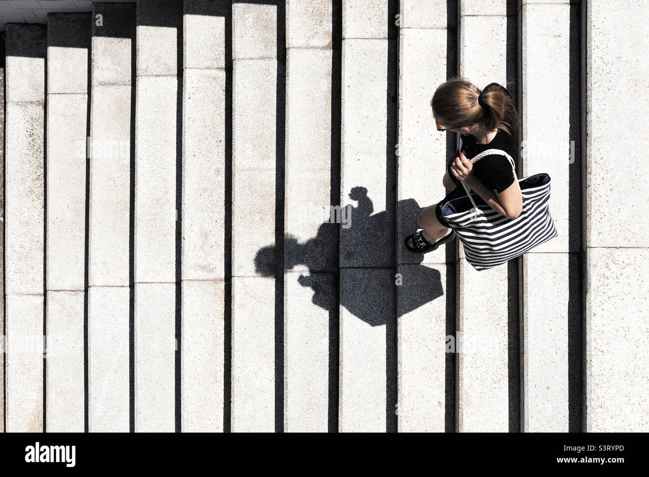 Top view of a woman going down stairs - Smartphone Captured Stock Image
