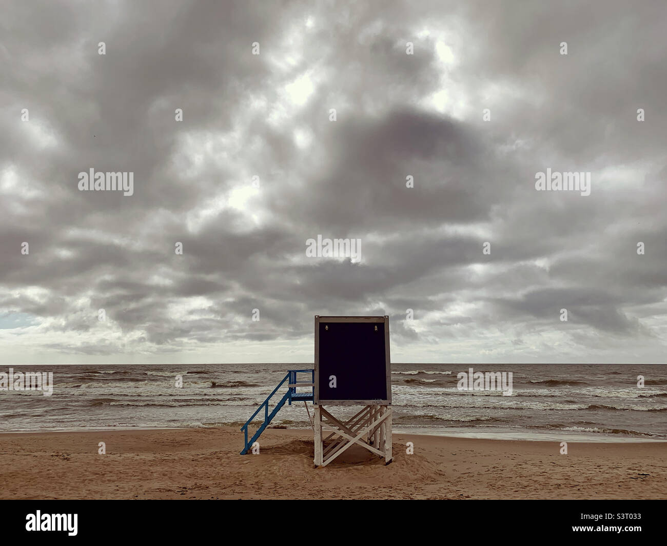 Lonely wooden building in moody empty beach - Smartphone Captured Stock Image
