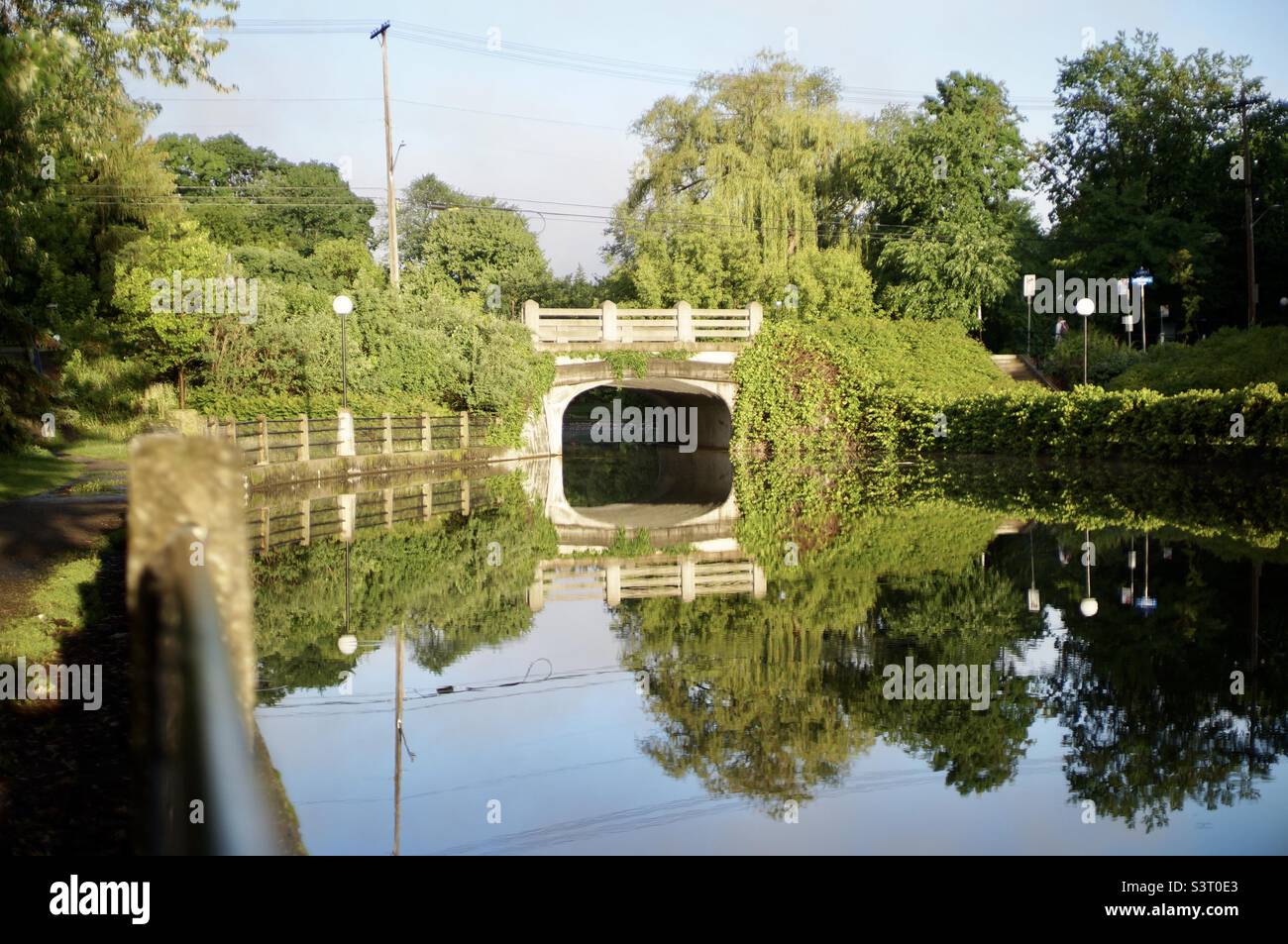 Early morning reflection of the O’Connor street bridge over Patterson Creek. - Smartphone Captured Stock Image