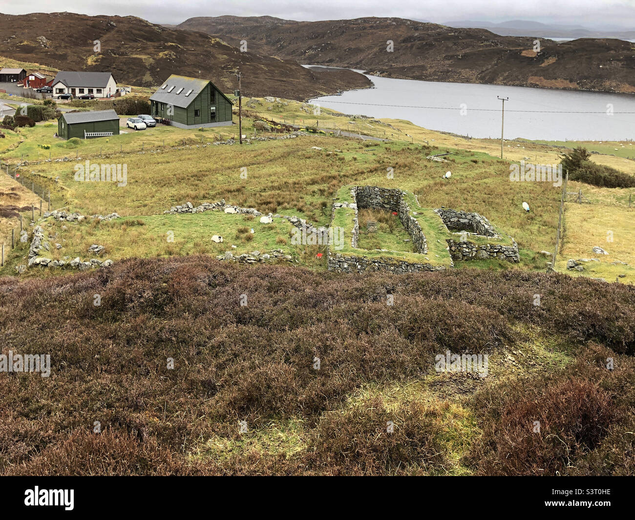 Old Black House covered in grass at Dun Carloway, Isle of Lewis, Outer Hebrides, Scotland, United Kingdom - Smartphone Captured Stock Image
