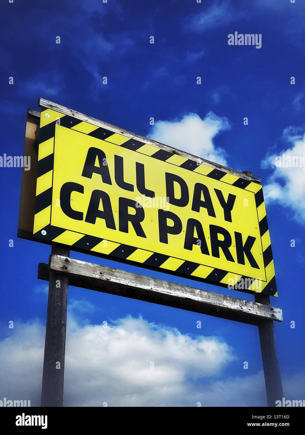 “ALL DAY CAR PARK” A large sign at a seaside town somewhere in Europe. Photo ©️ COLIN HOSKINS. Stock Photo