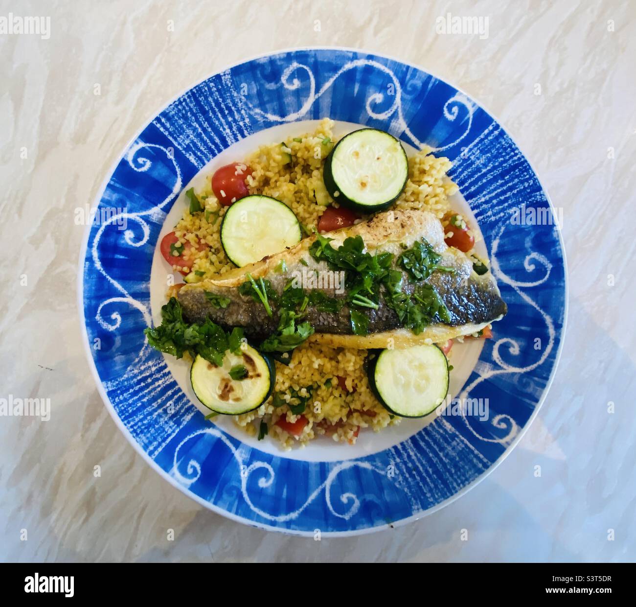 Hello Fresh meal. Lemon and Herb Sea Bass with Bulgur, Charred Courgettes and Herby Dressing. 11 June 2022. - Smartphone Captured Stock Image