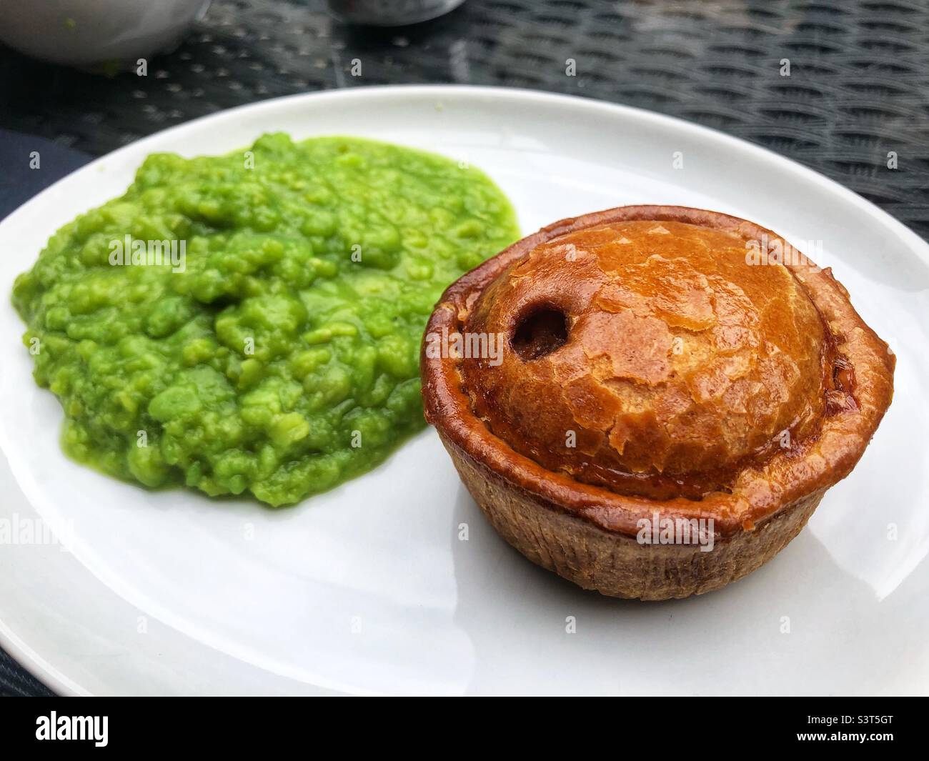 Traditional pie and peas on a plate Stock Photo