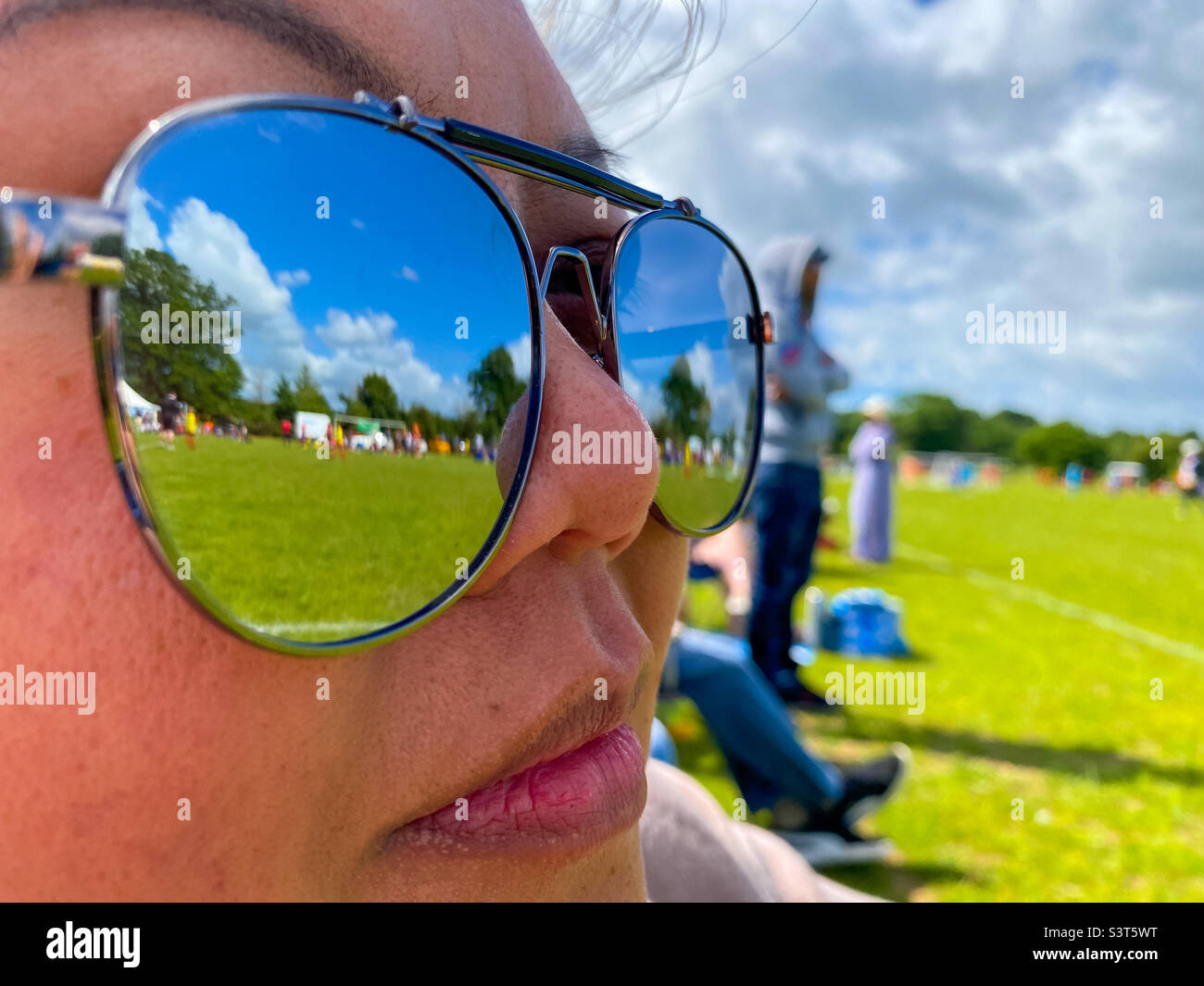 Reflections in the lenses of a pair of sunglasses worn by an Asian lady. Stock Photo