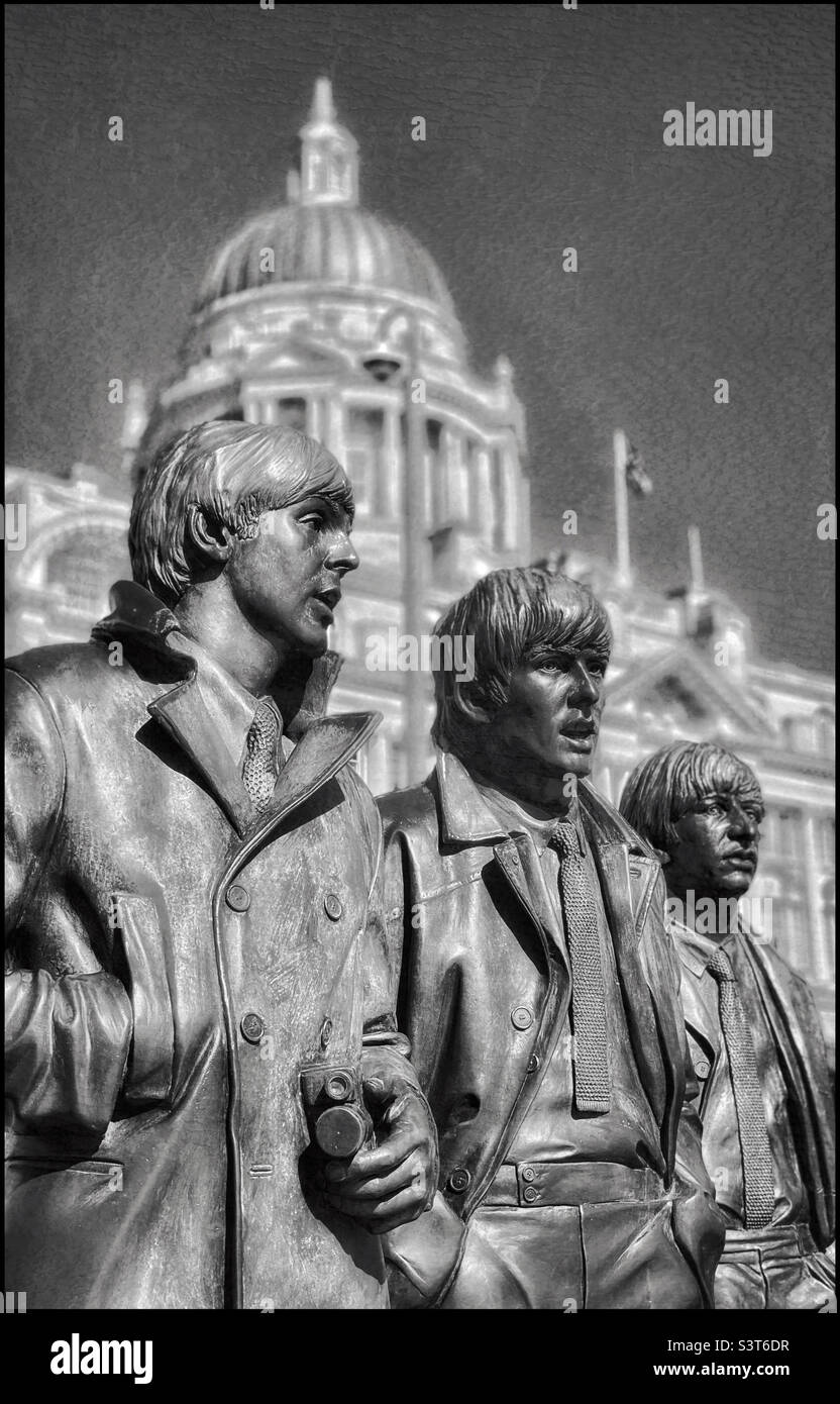 The famous “Beatles” bronze sculpture depicting 3 of the legendary “Fab Four” @ the Pier Head in Liverpool, England. Shown here are Paul McCartney, George Harrison & Ringo Star. Photo ©️ COLIN HOSKINS Stock Photo