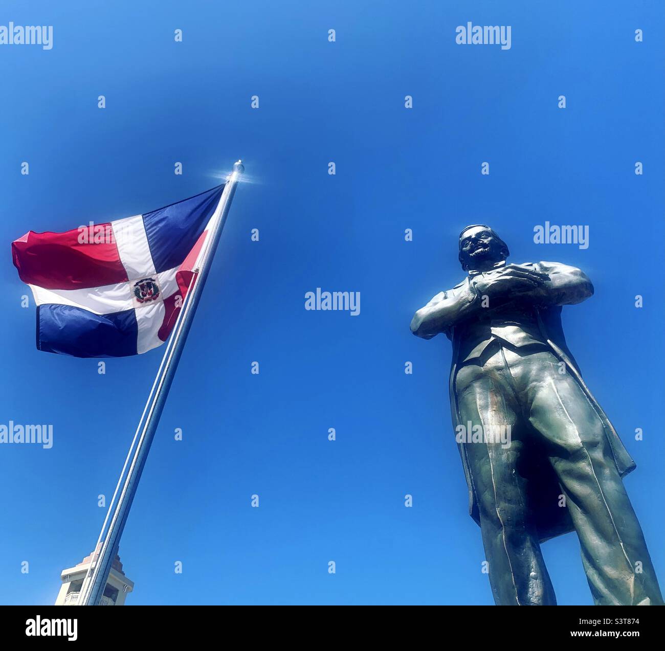 March, 2022, Flag and statue, Central Park, Puerto Plata, Dominican Republic Stock Photo