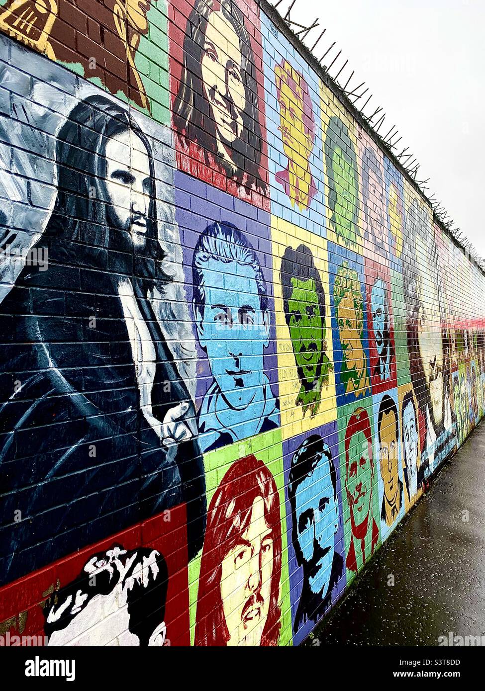 Mural on Peace wall in Belfast depicting famous faces Stock Photo