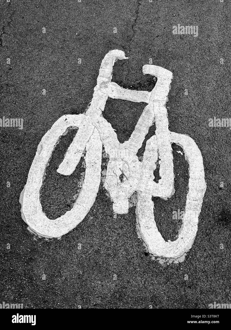 The hand drawn and painted image of a bicycle indicates this area is designated for cyclists. This is a cycle lane! Photo ©️ COLIN HOSKINS. Stock Photo