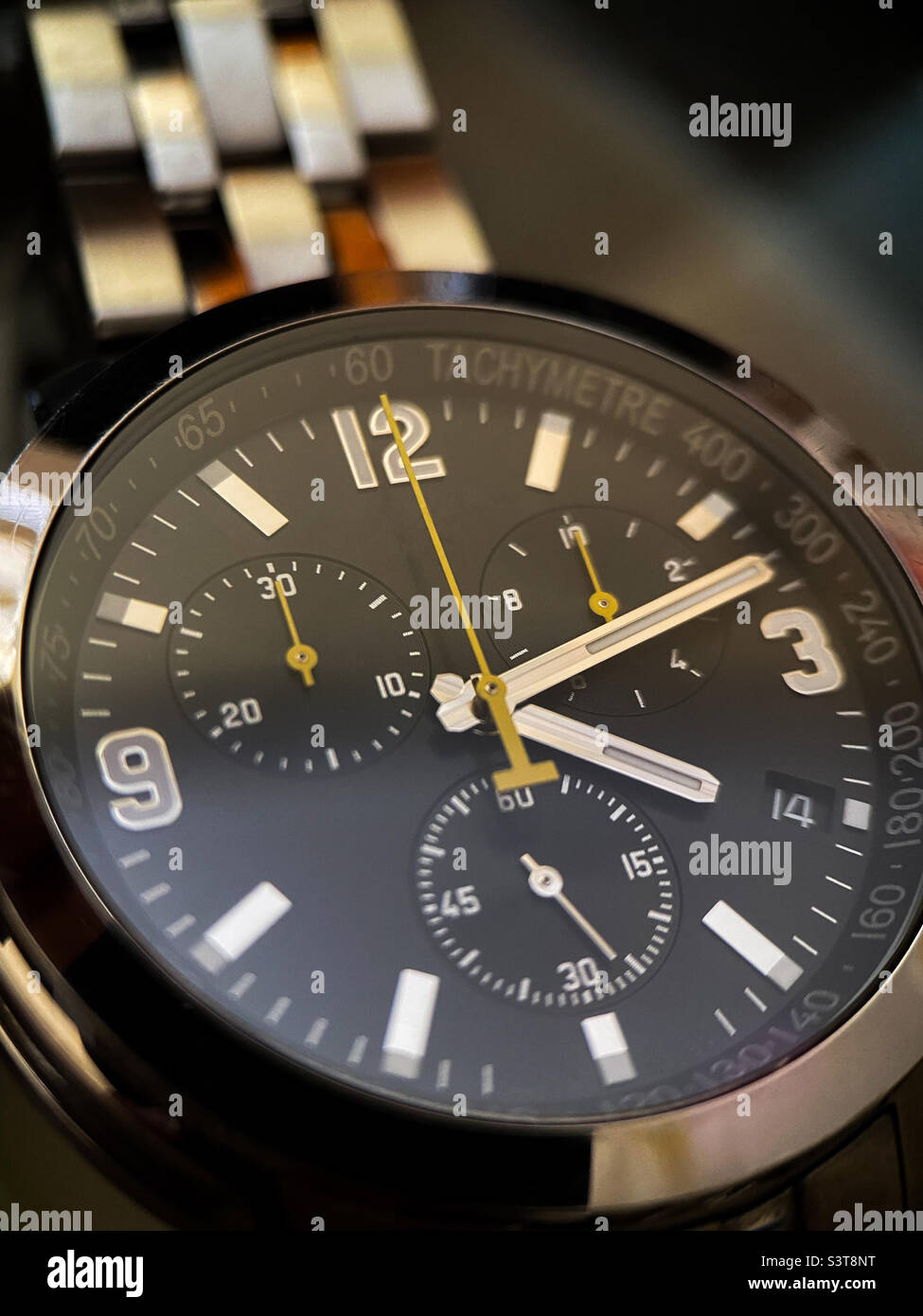 Luxury stainless steel watch with chronograph, black dial and metal bracelet close-up. Macrophotography of watch details - Smartphone Captured Stock Image