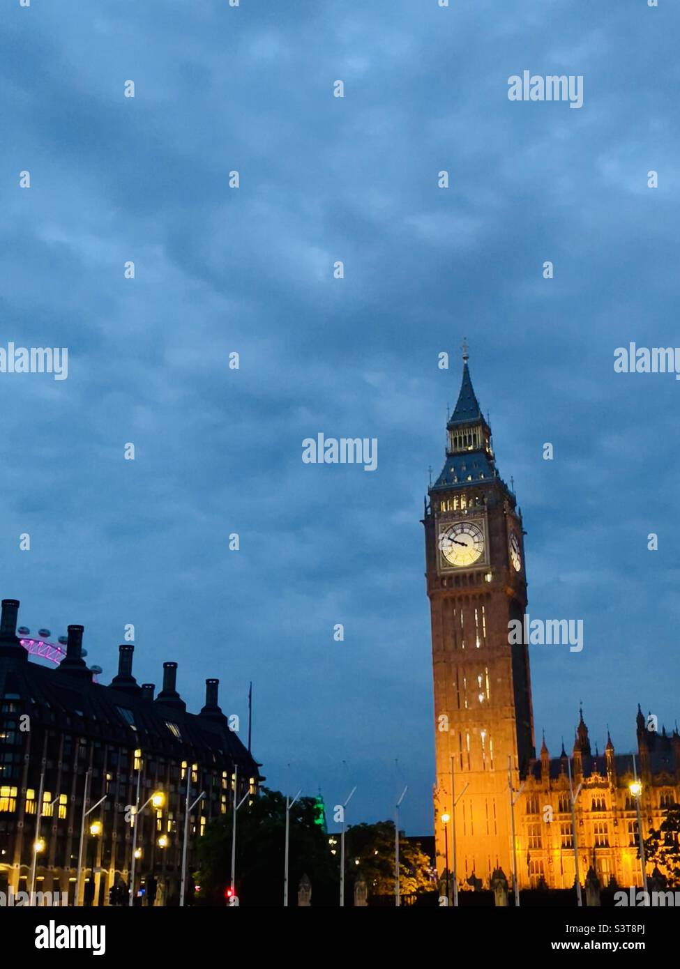Westminster at dusk with Houses of Parliament, Portcullis House and the London Eye looking towards Westminster Bridge June 2022 - Smartphone Captured Stock Image