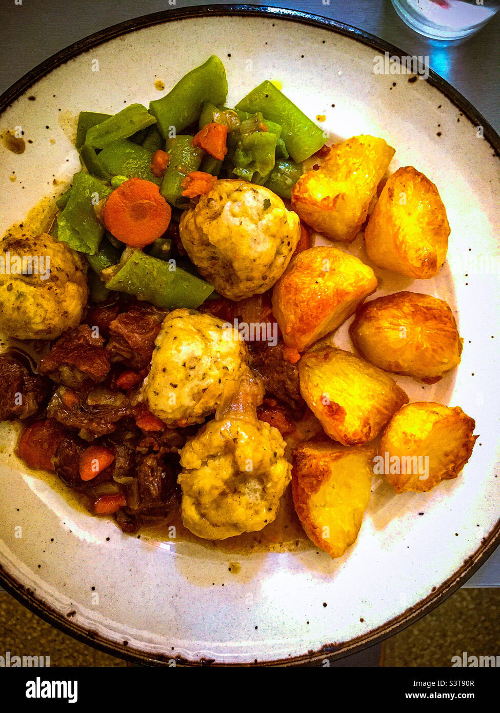 Beef stew and dumplings with roasted potatoes and vegetables Stock
