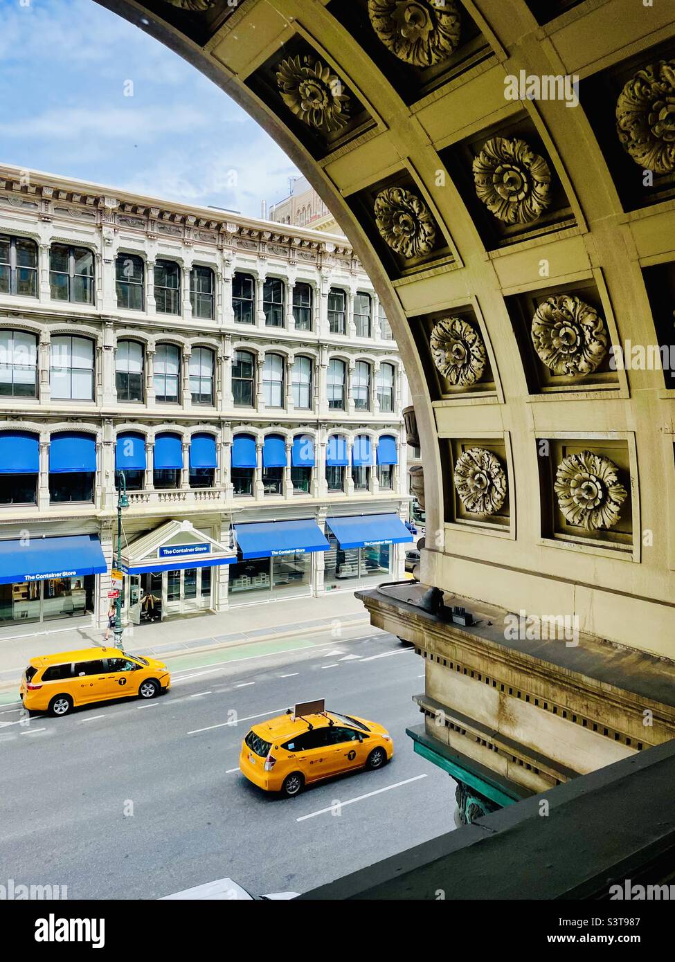 Yellow taxis, blue awnings & architectural detail on Sixth Avenue, New York City, USA Stock Photo