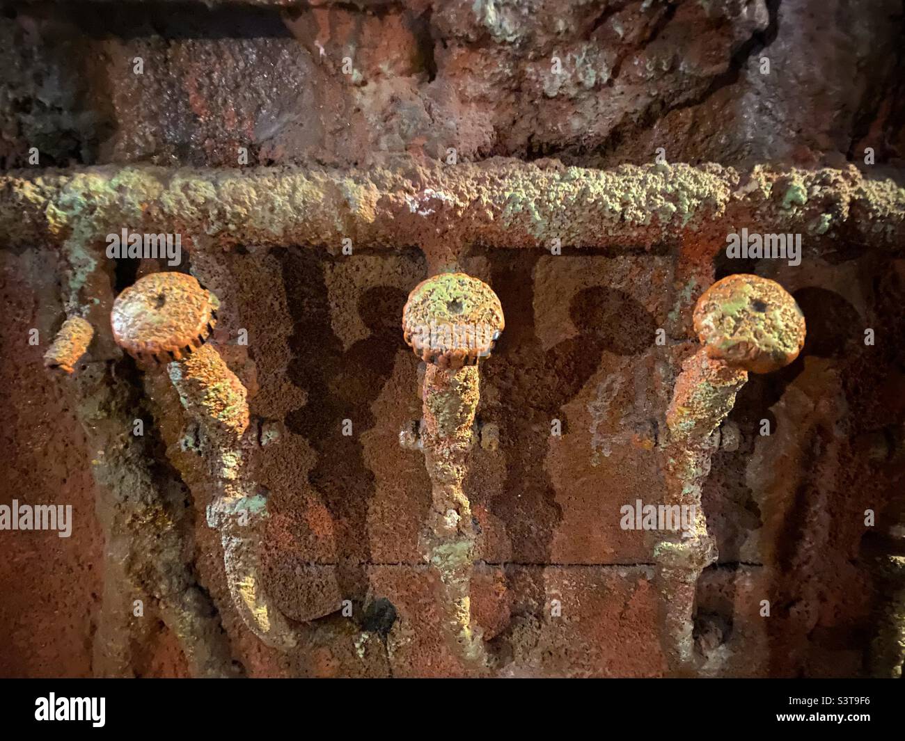 Rusted pipes and three faucets from an old ship or submarine Stock Photo