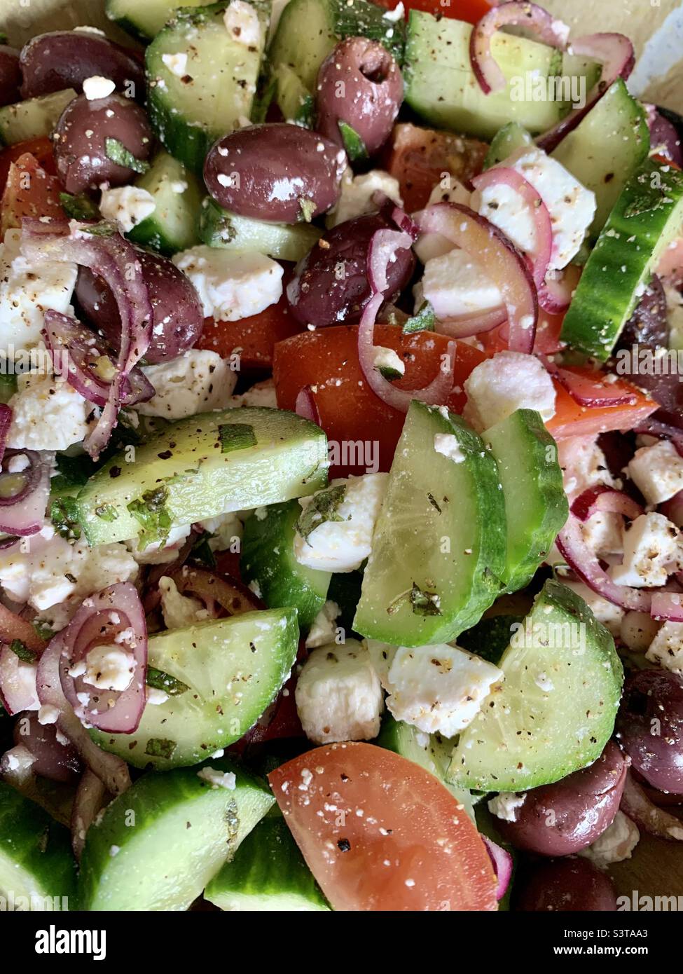Greek salad with cucumber tomatoes red onion olives and feta cheese Stock Photo