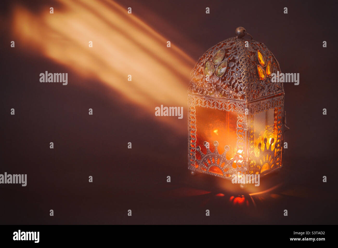 Antique Arabic lantern in a dark room with ray of light falling on it Stock Photo