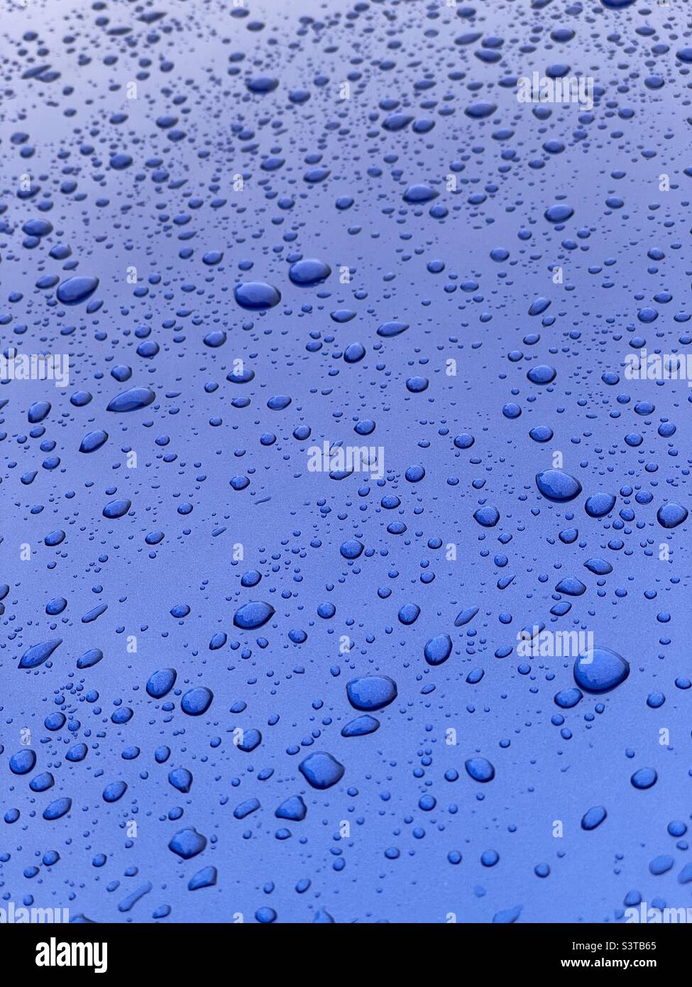 Raindrops on blue car - Smartphone Captured Stock Image