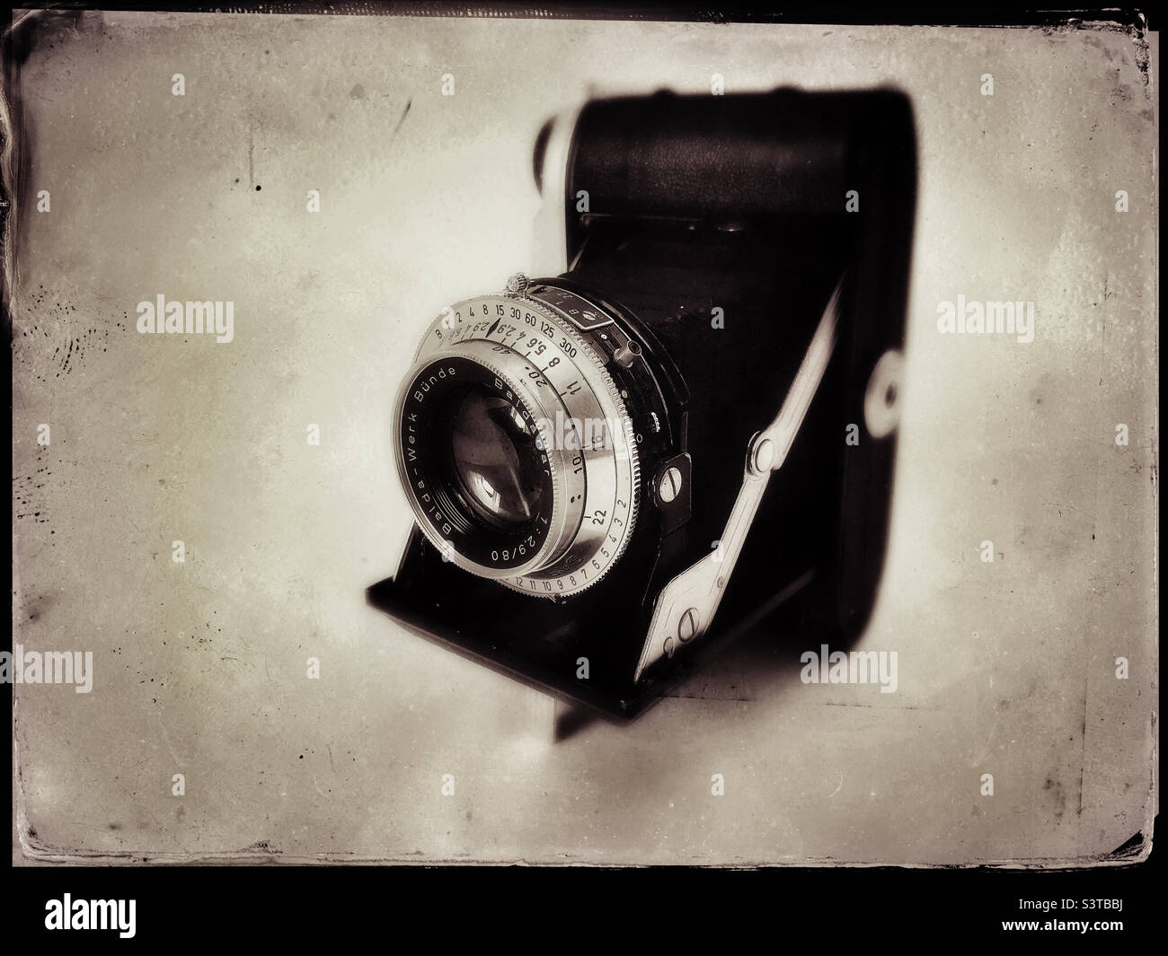 Vintage camera folding bellowed camera from 1930s  image edited to give it a  vintage  wet  plate photo look Stock Photo