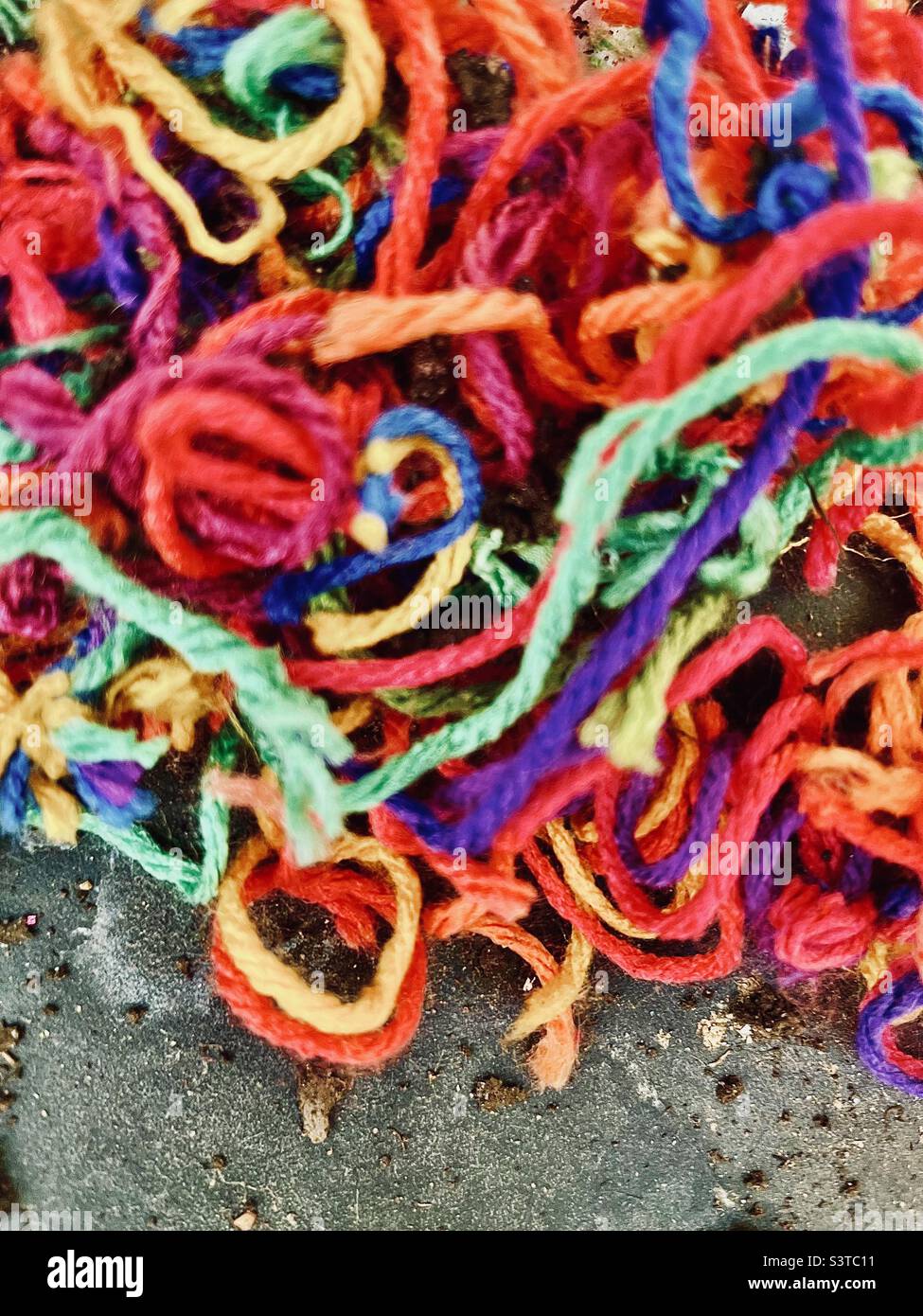 Rainbow yarn on sidewalk Stock Photo