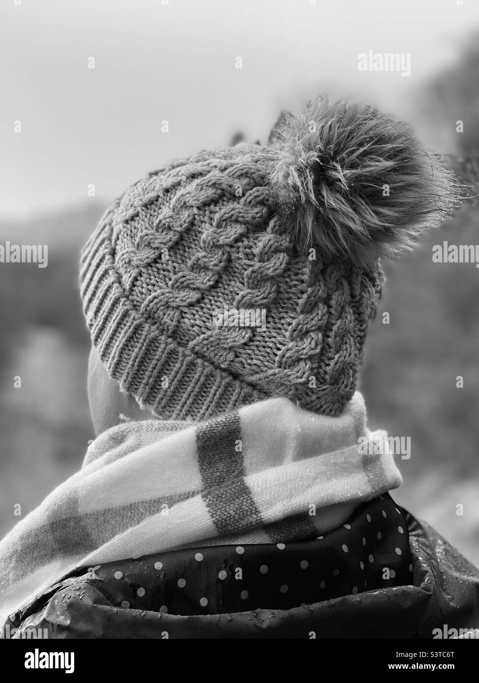 Rear view of woman wearing a knit hat and scarf Stock Photo