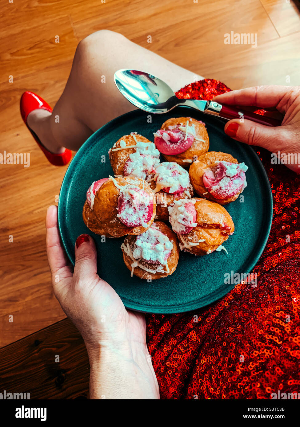 Woman holding a plate of profiteroles - Smartphone Captured Stock Image