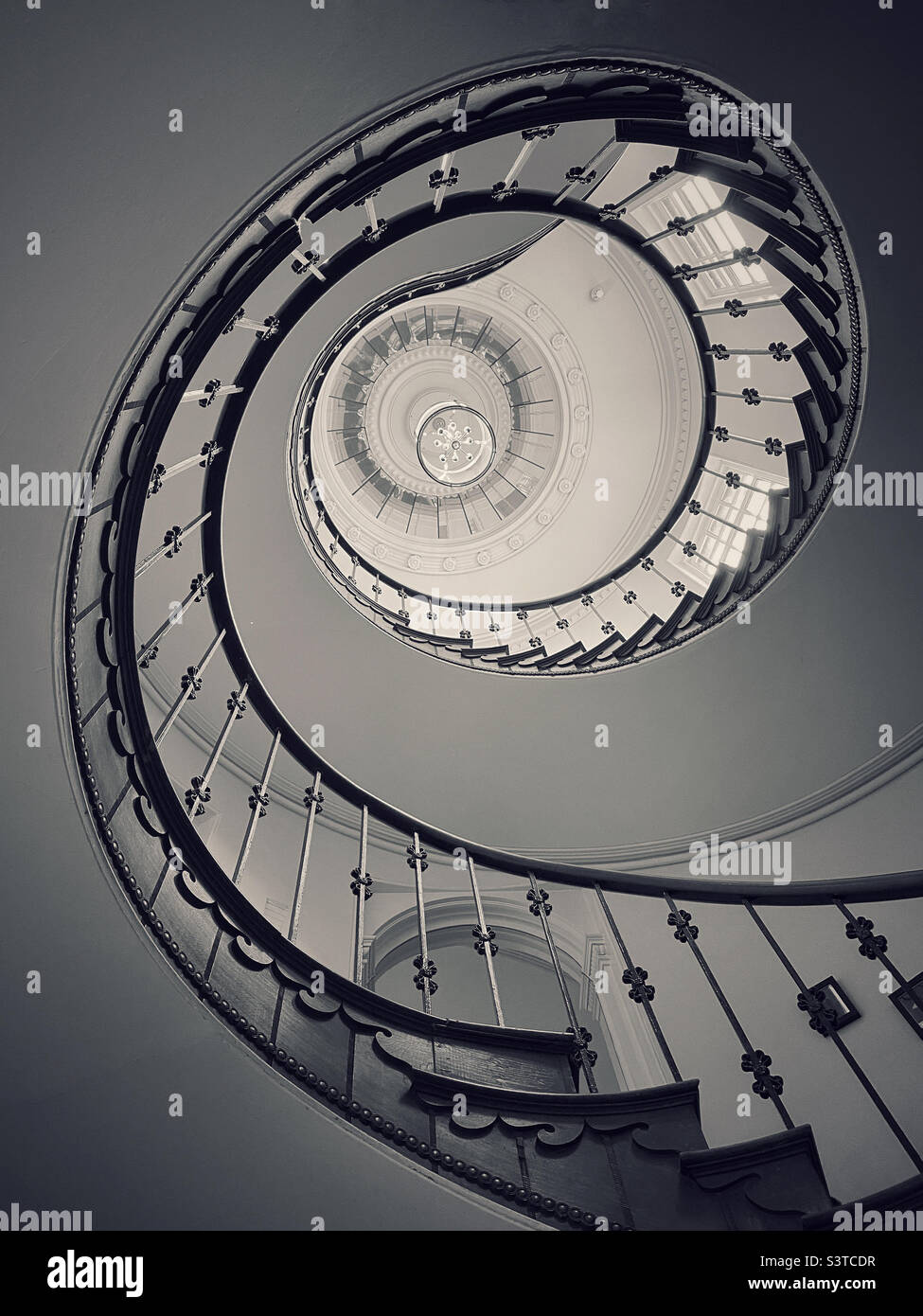 The view from the bottom of a spiral staircase, looking up. There’s something satisfying about geometric shapes! Photo ©️ COLIN HOSKINS. Stock Photo