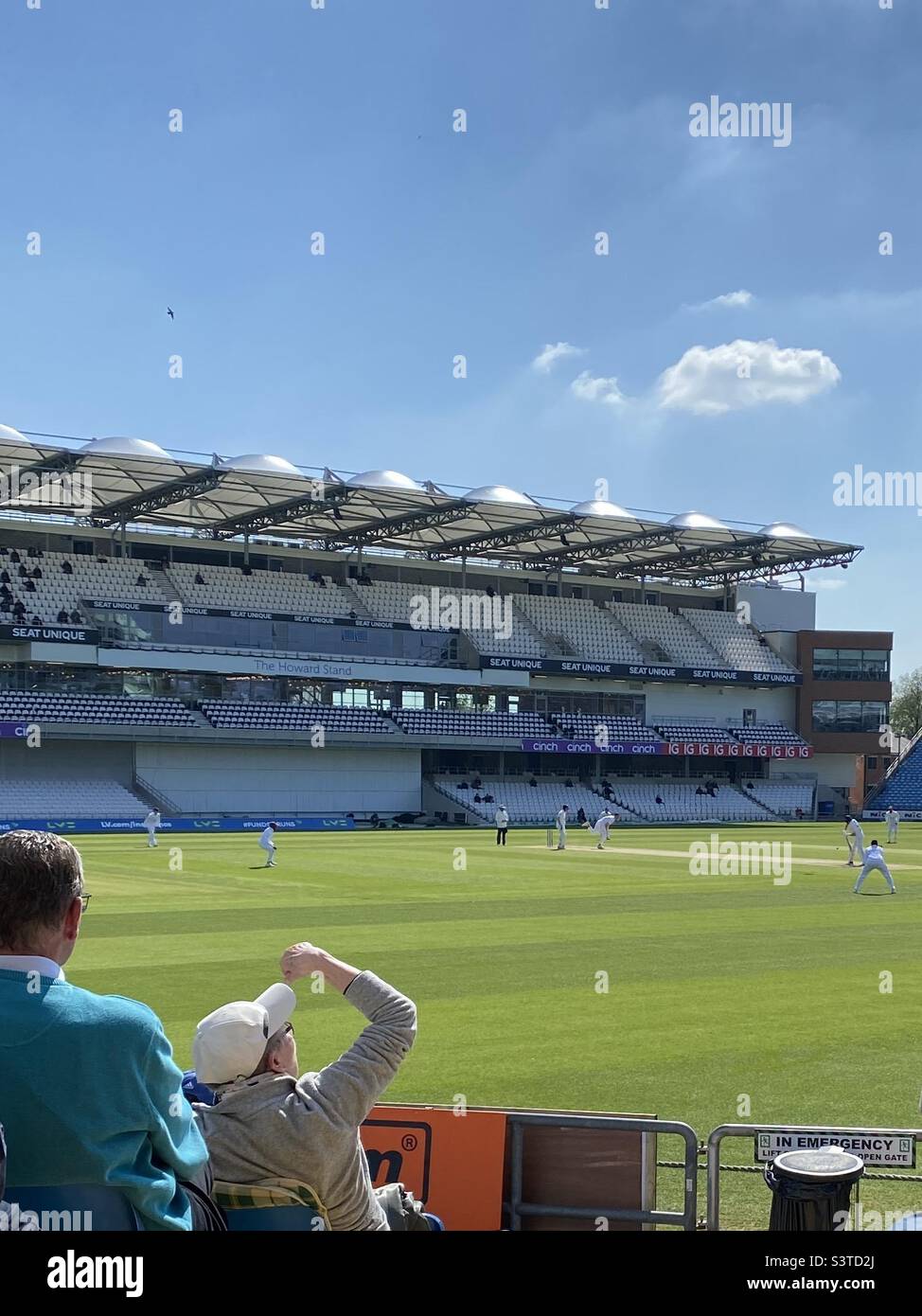 Red ball (traditional) cricket against Kent at Headingley Cricket Ground, Leeds, UK, home of Yorkshire County Cricket Club, on 29th April, 2022. Planes fly overhead to nearby Leeds-Bradford Airport. Stock Photo