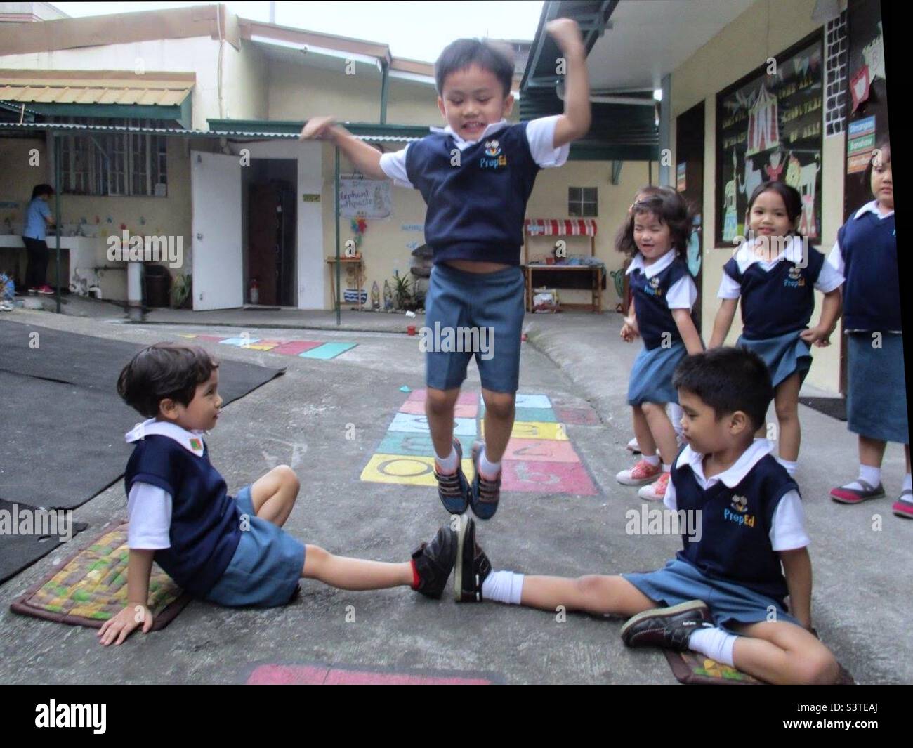 Children play Luksong Tinik in Filipino it means Jump ath thorns Stock Photo