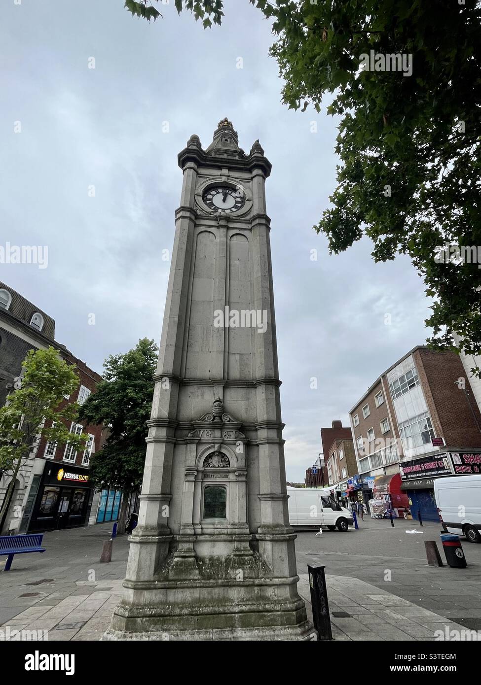 Clock tower, Lewisham High Street, London, looks towards street market setting up in the morning, clock stopped. Grade II Listed. Commemorates Queen Victoria’s diamond jubilee - Smartphone Captured Stock Image