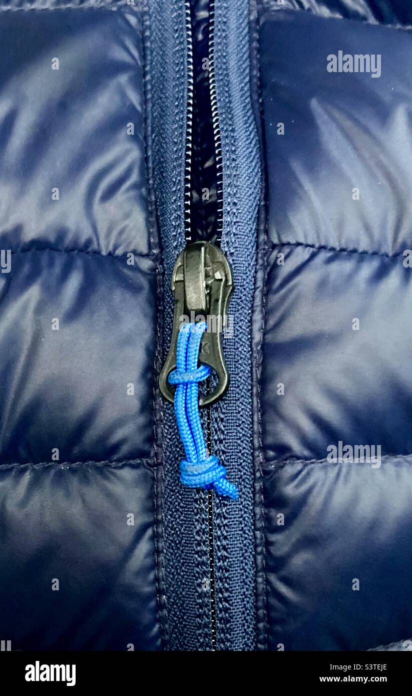 Zip on a navy blue puffer coat close up - Smartphone Captured Stock Image