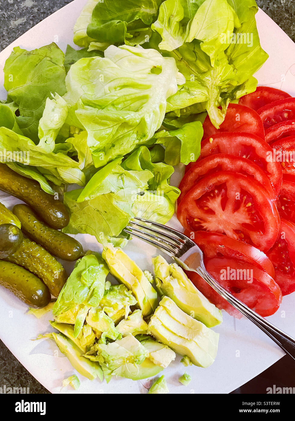 Close-up of a vegetable platter of all the trimmings for a hamburger cookout, 2022, summertime, north eastern United States - Smartphone Captured Stock Image