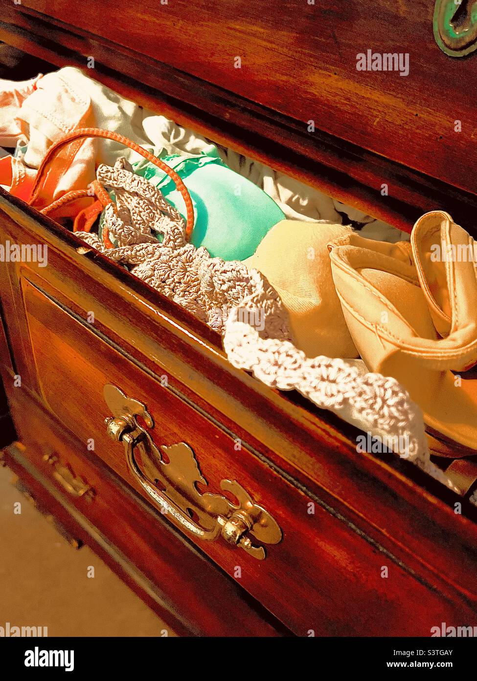 Woman’s dresser with open bras and panties drawer Stock Photo