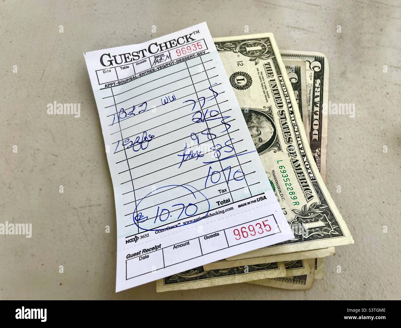 A Restaurant receipt and cash payment Stock Photo