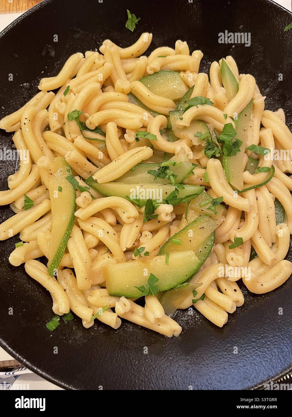 Delicious homemade pasta with zucchini and garlic sauce - Smartphone Captured Stock Image