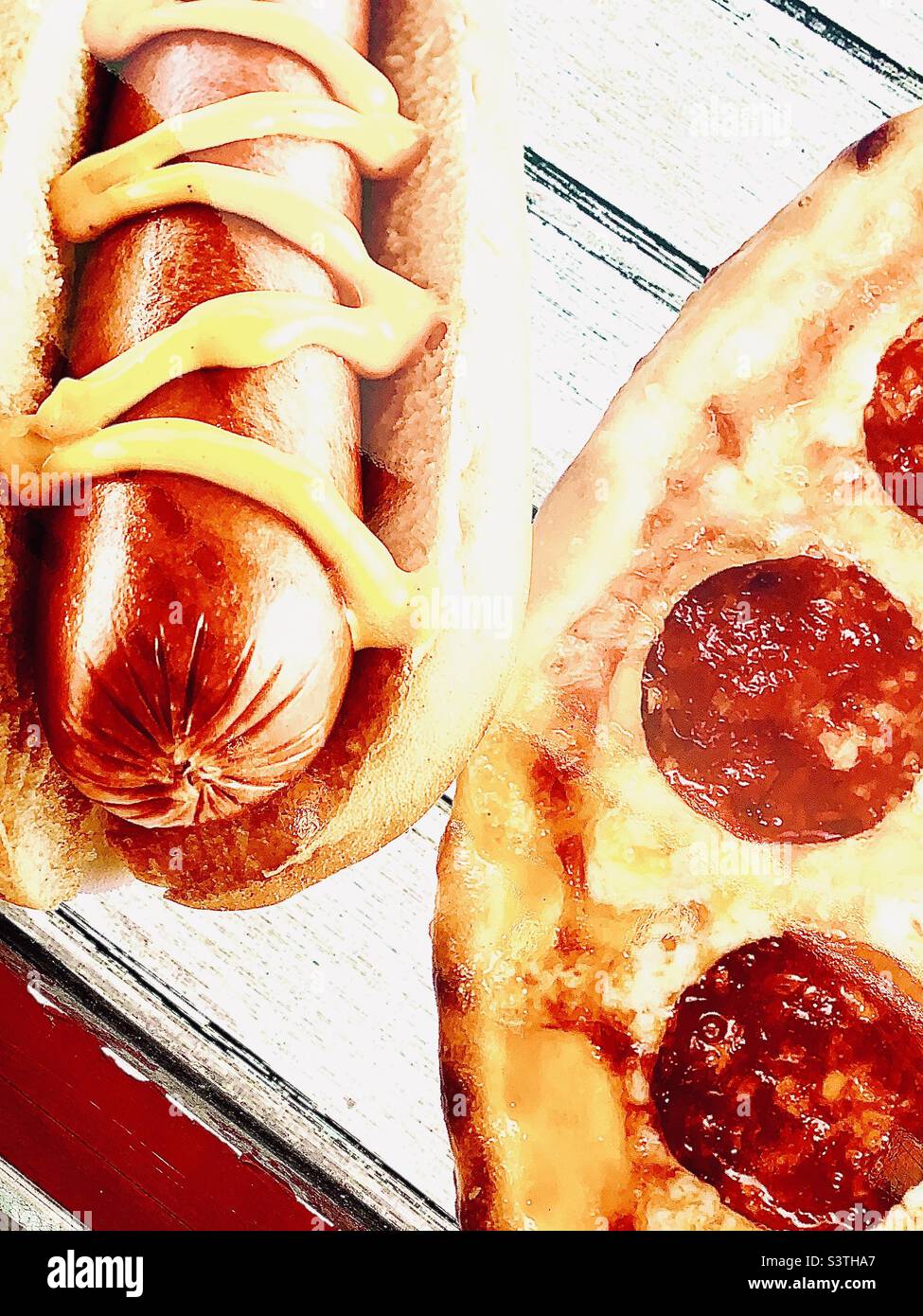 Hot dog with mustard and pepperoni pizza - Smartphone Captured Stock Image