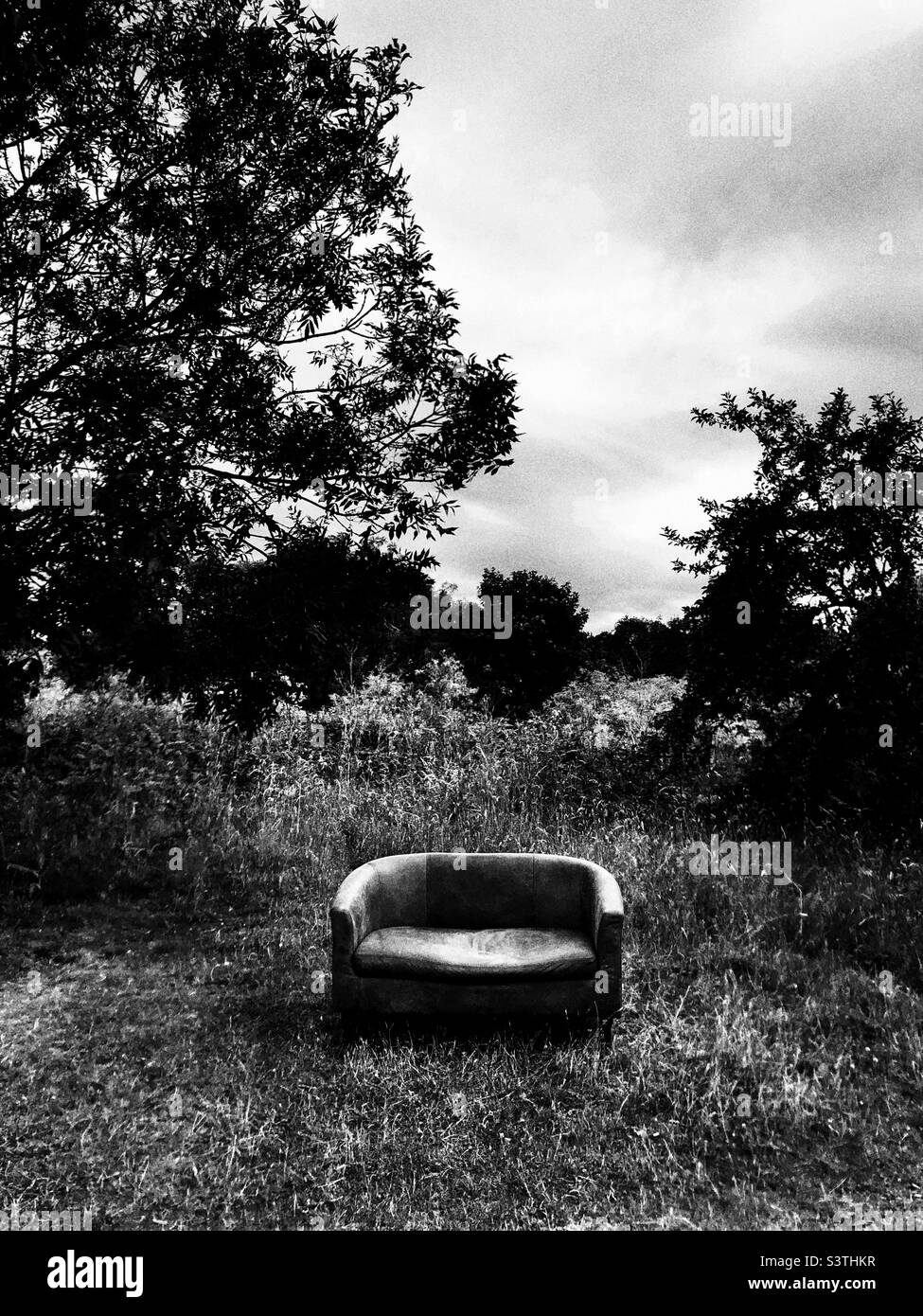 Abandoned sofa in the field - Smartphone Captured Stock Image