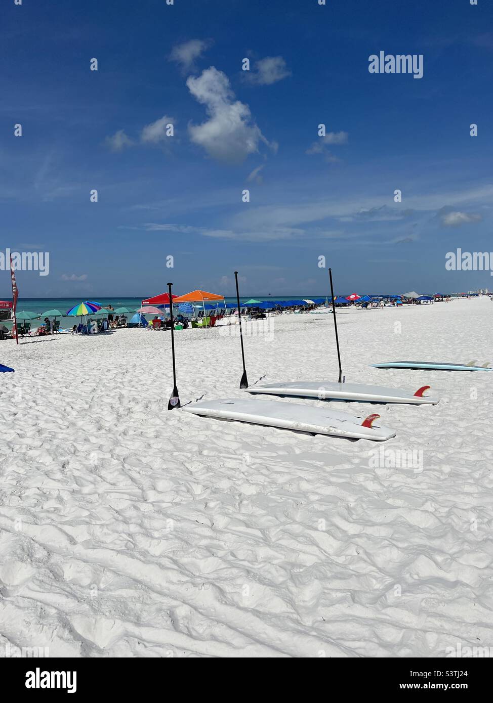 Destin Florida USA white sand beach with umbrellas, chairs and paddle boards - Smartphone Captured Stock Image