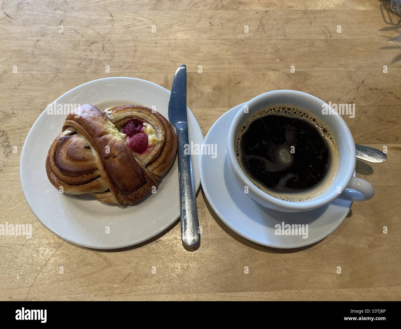 Raspberry and Vanilla sweet pastry with Americano black coffee - Smartphone Captured Stock Image