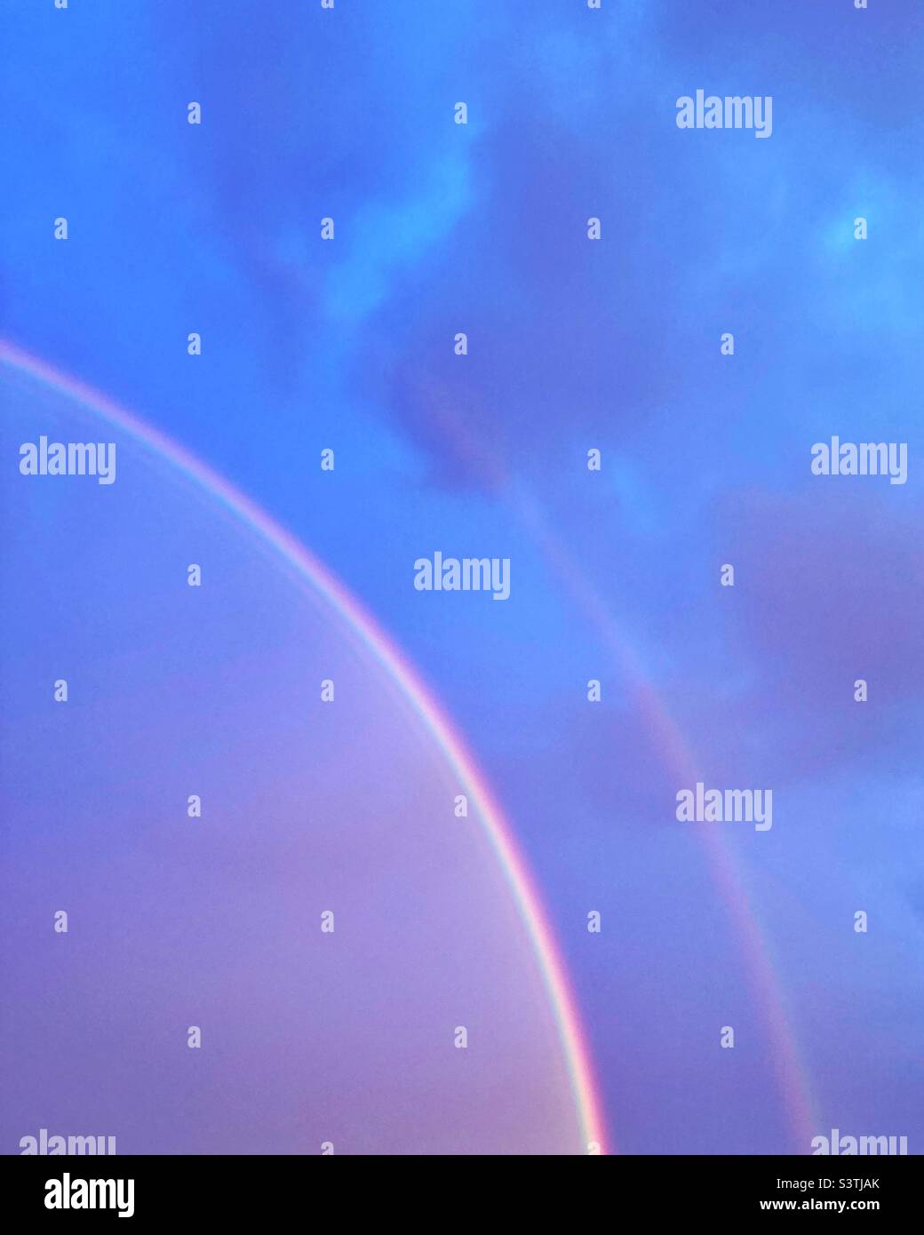 Double rainbow at sunset - Smartphone Captured Stock Image