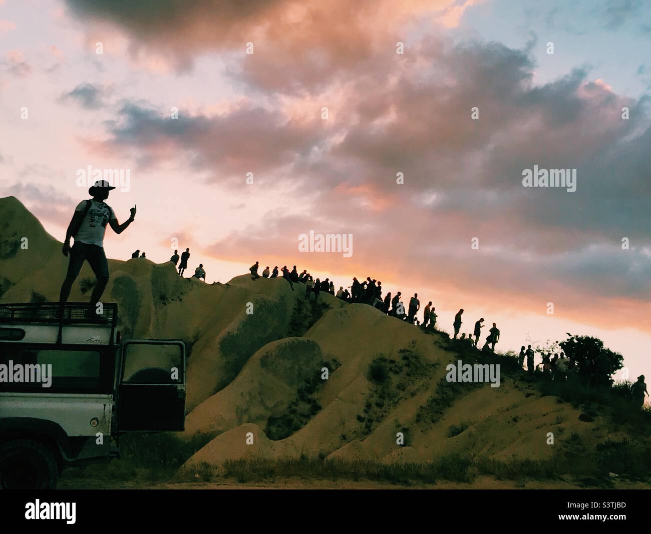 People gather to watch sunset at Rose Valley in Cappadocia, Turkey - Smartphone Captured Stock Image