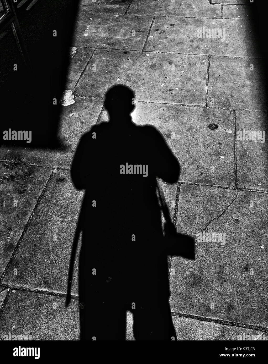 Shadow of a man with a camera - Smartphone Captured Stock Image