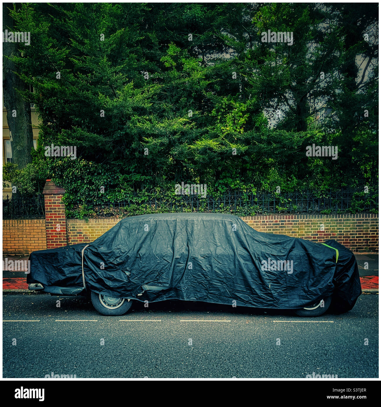 Covered car in black shroud Stock Photo Alamy