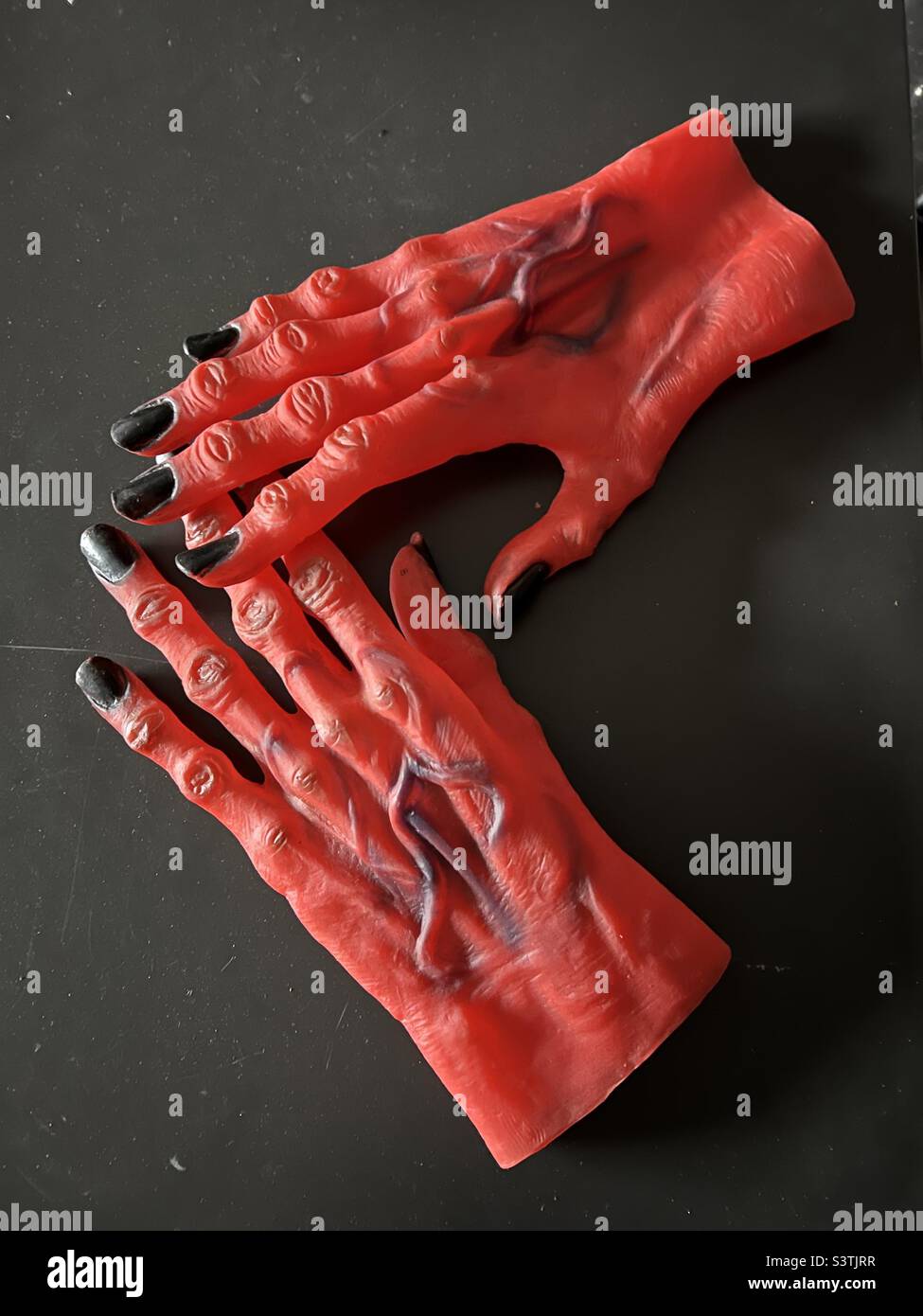 Plastic costume monster devil hands Stock Photo