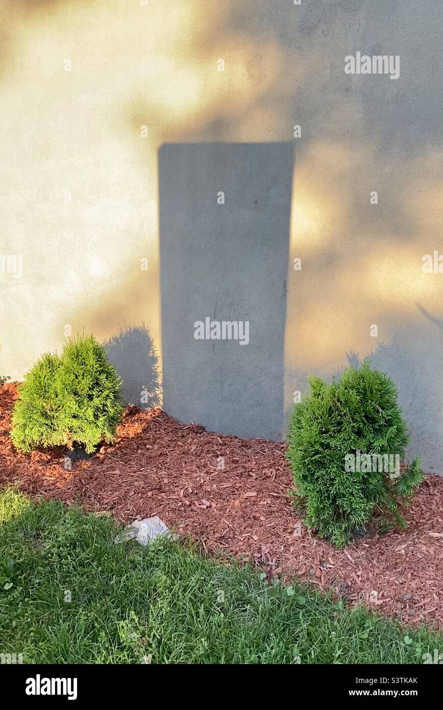 Early morning shadows against a church wall. - Smartphone Captured Stock Image